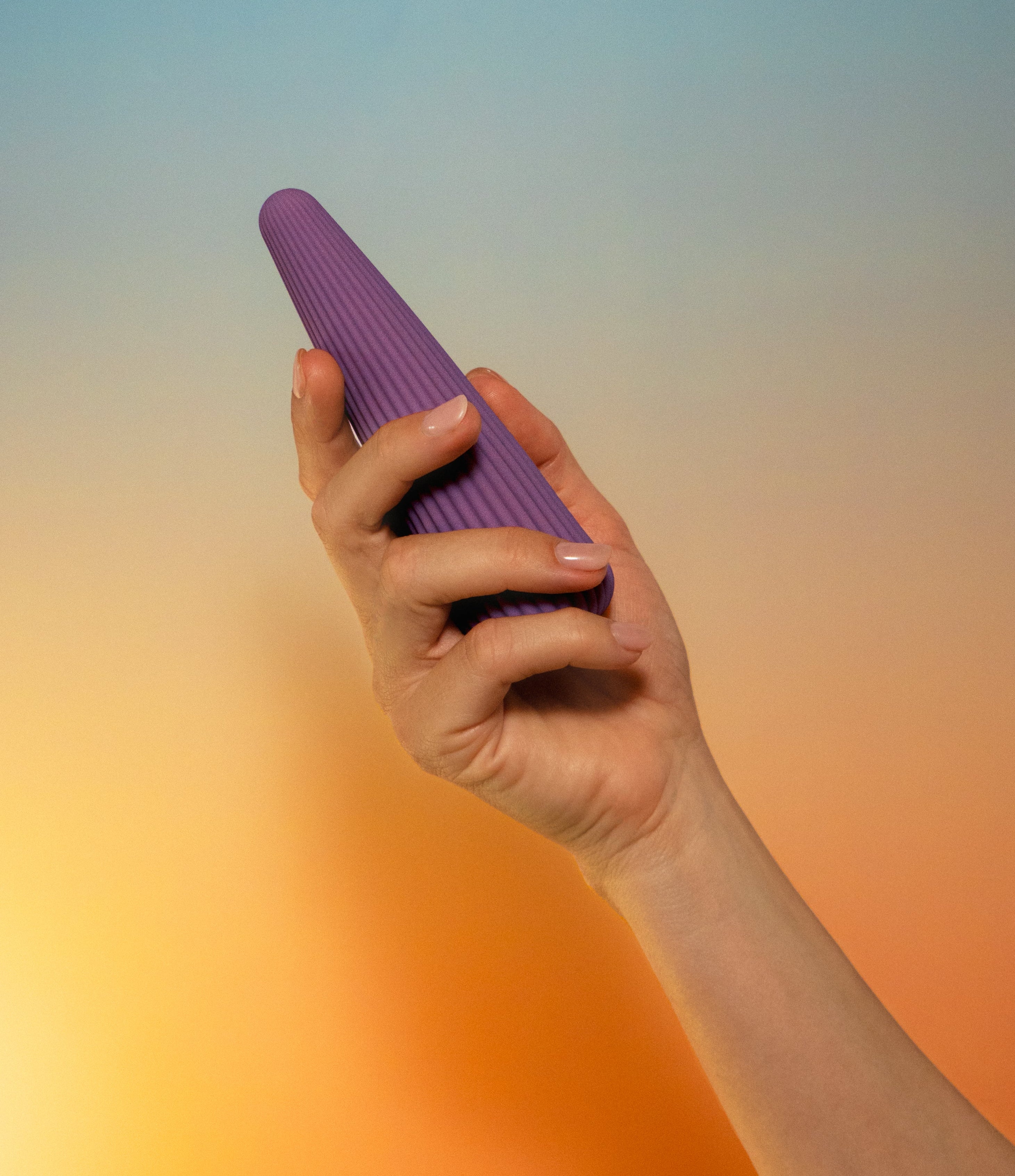 Labas Cyra ergonomic pleasure massager held in hand to show its elegant curved design and premium silicone texture for targeted stimulation.