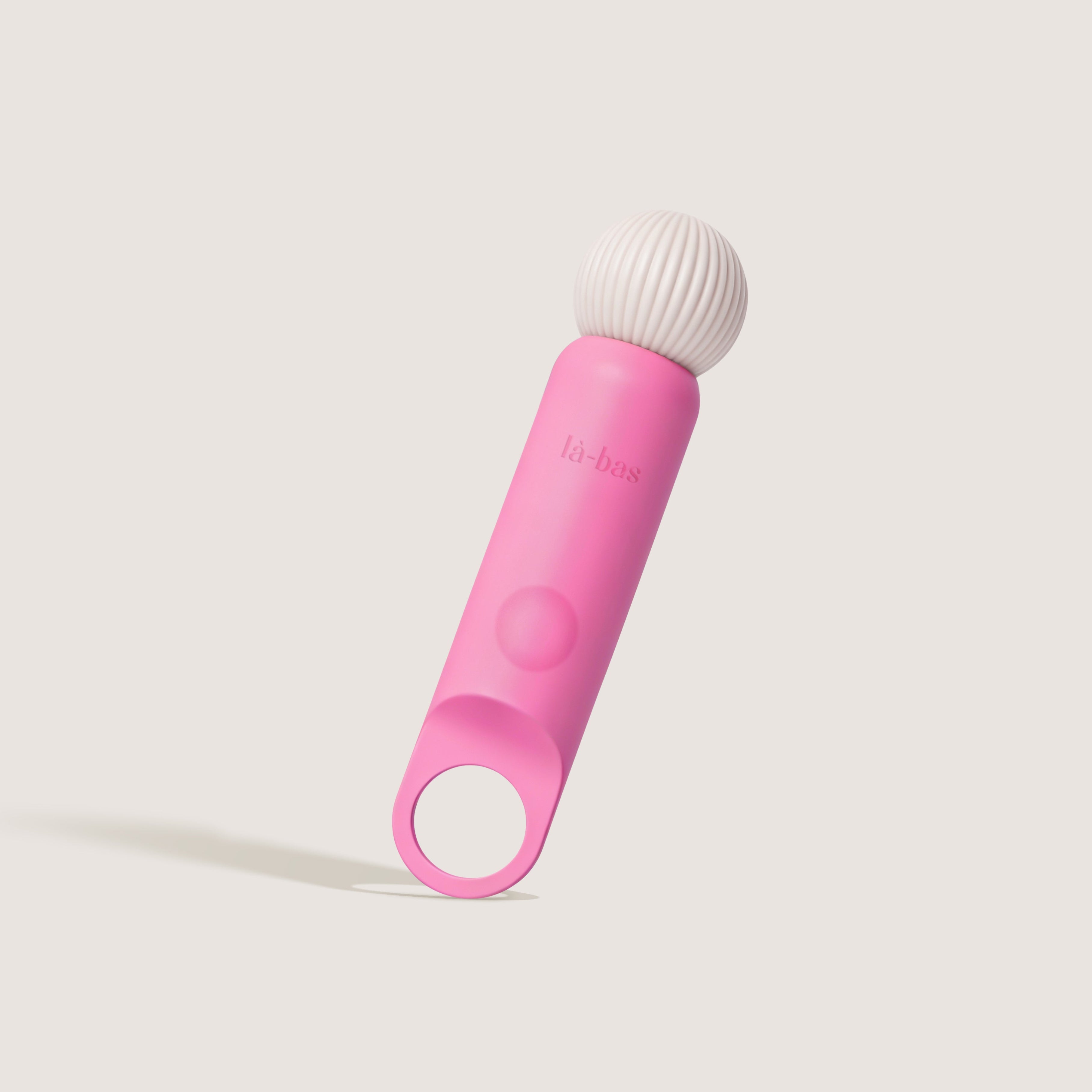 La-bas angled shot of the Veya pink vibrator featuring a ring-shaped base and ribbed massage head.
