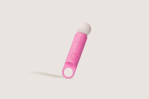La-bas angled shot of the Veya pink vibrator featuring a ring-shaped base and ribbed massage head.