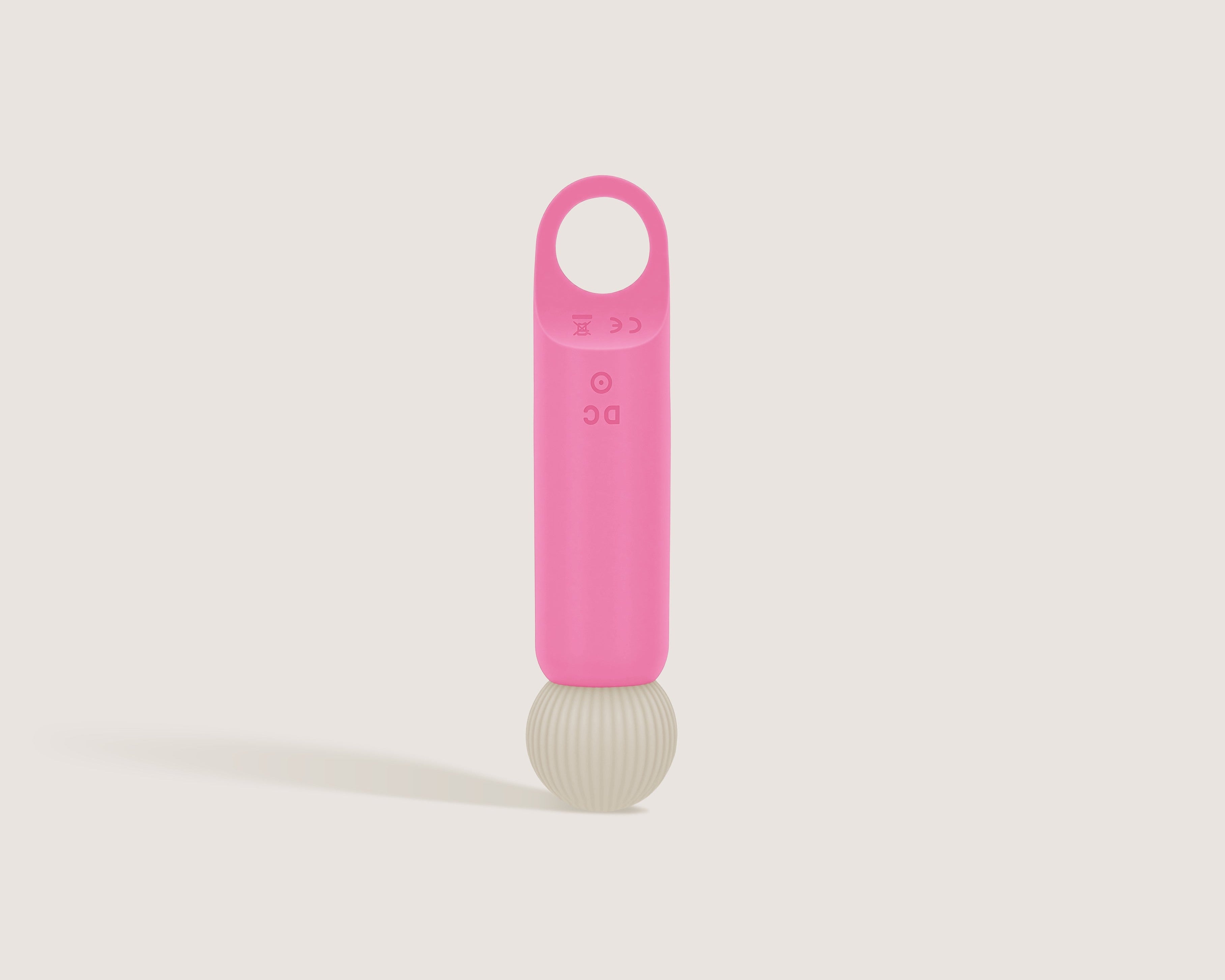 Back view of the pink Veya massager showing the DC charging port and CE certification marks.